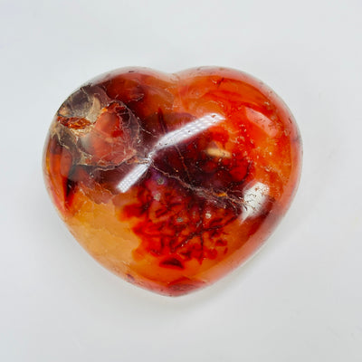 carnelian heart with decorations in the background