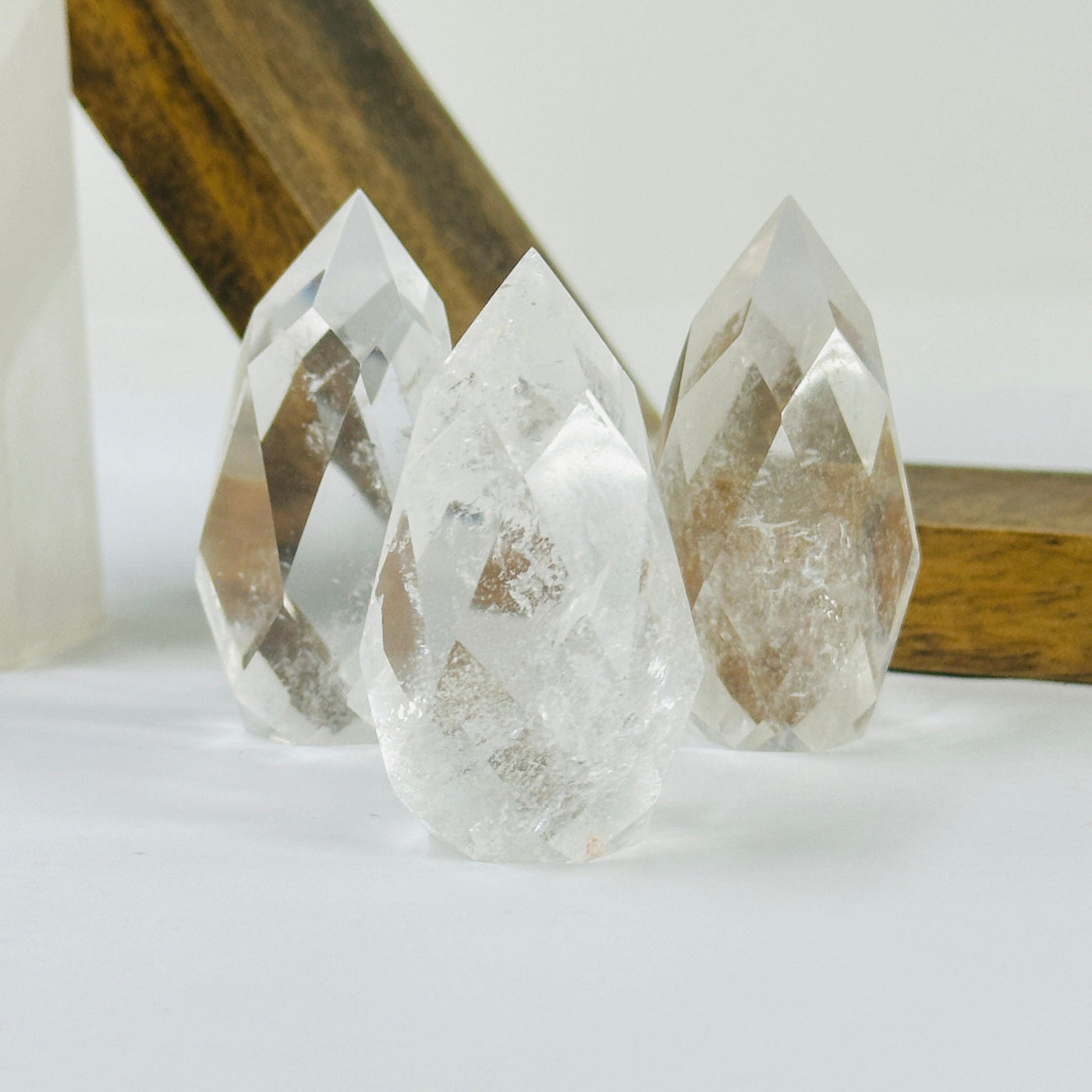 crystal quartz point with decorations in the background