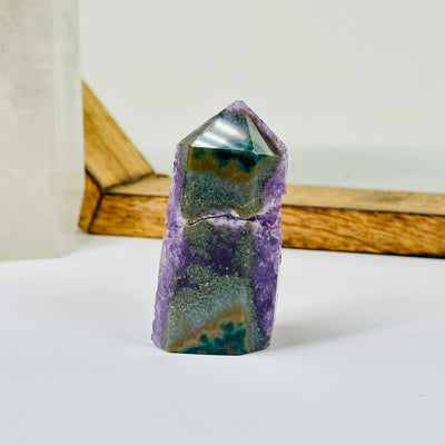 AMETHYST point with decorations in the background