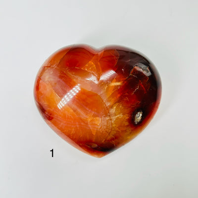 carnelian heart with decorations in the background