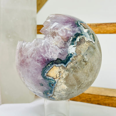 amethyst sphere with decorations in the background