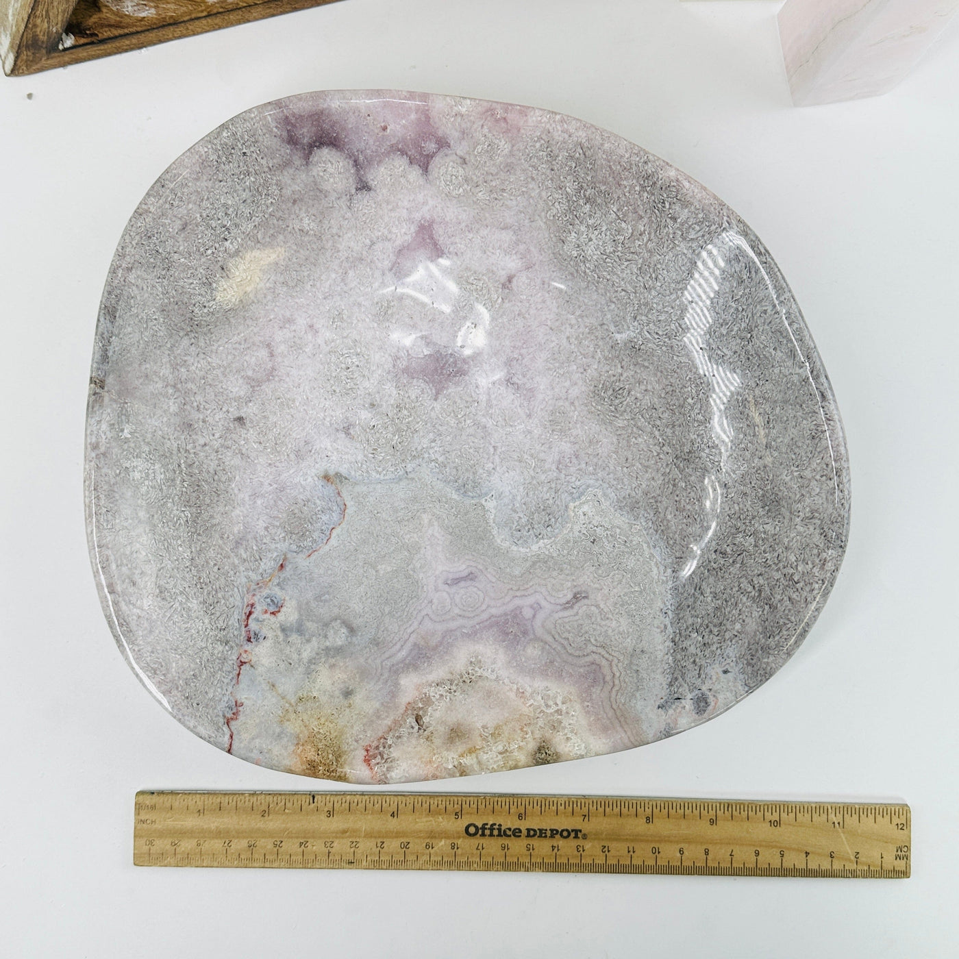 pink amethyst plate next to a ruler for size reference
