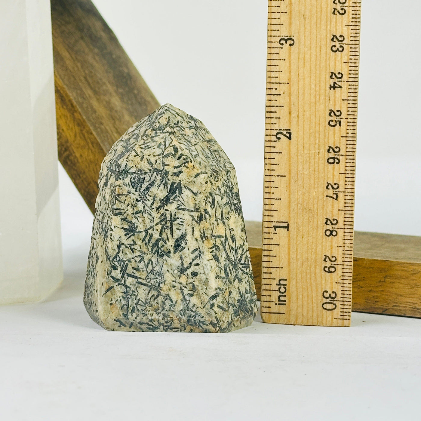 epidote point next to a ruler for size reference