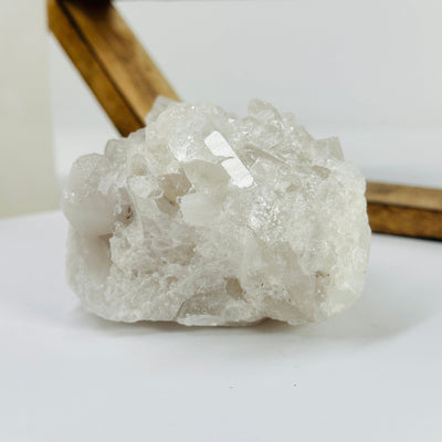 crystal quartz cluster with decorations in the background