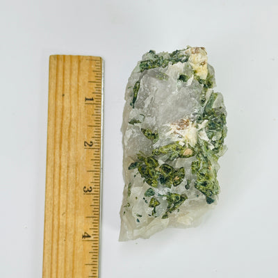 tourmaline next to a ruler for size reference