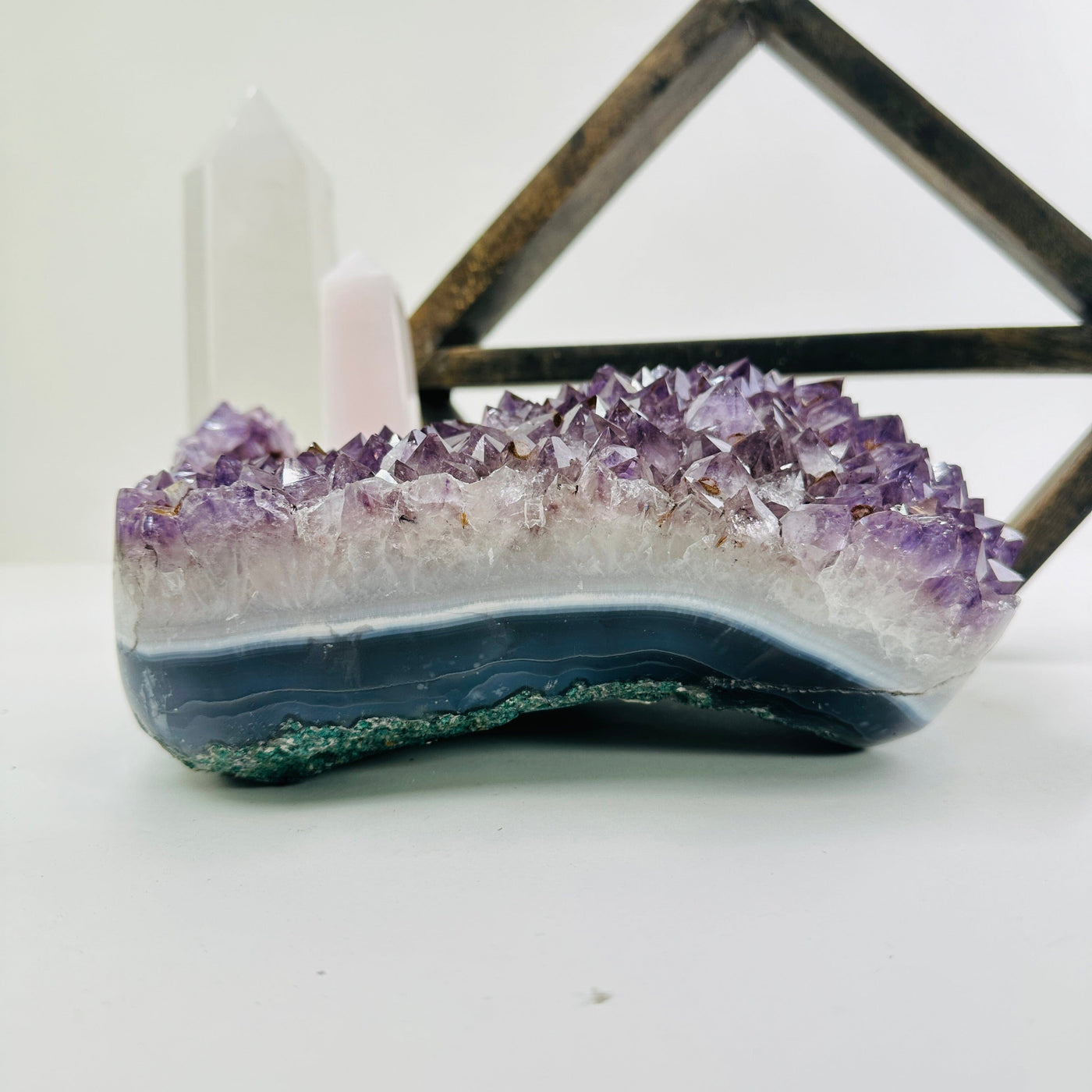 amethyst cluster with decorations in the background