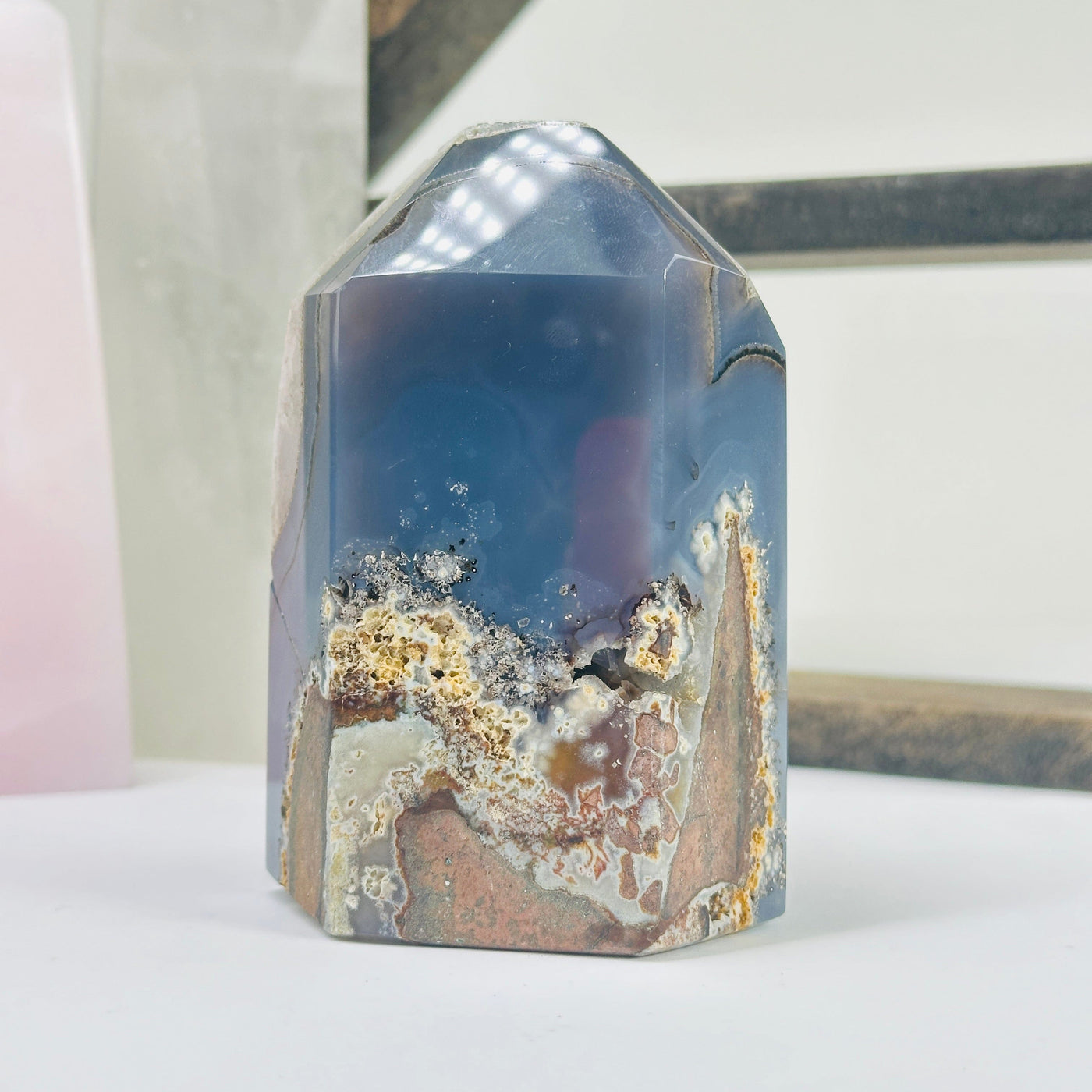amethyst agate point with decorations in the background