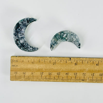 amethyst druzy moons next to a ruler for size reference
