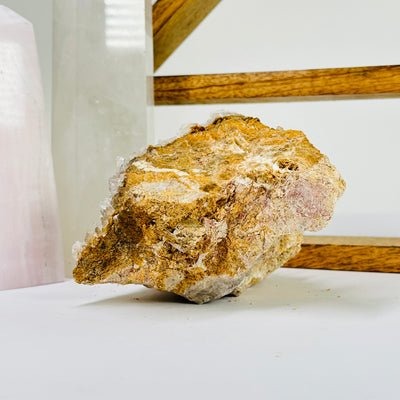 calcite on matrix with decorations in the background