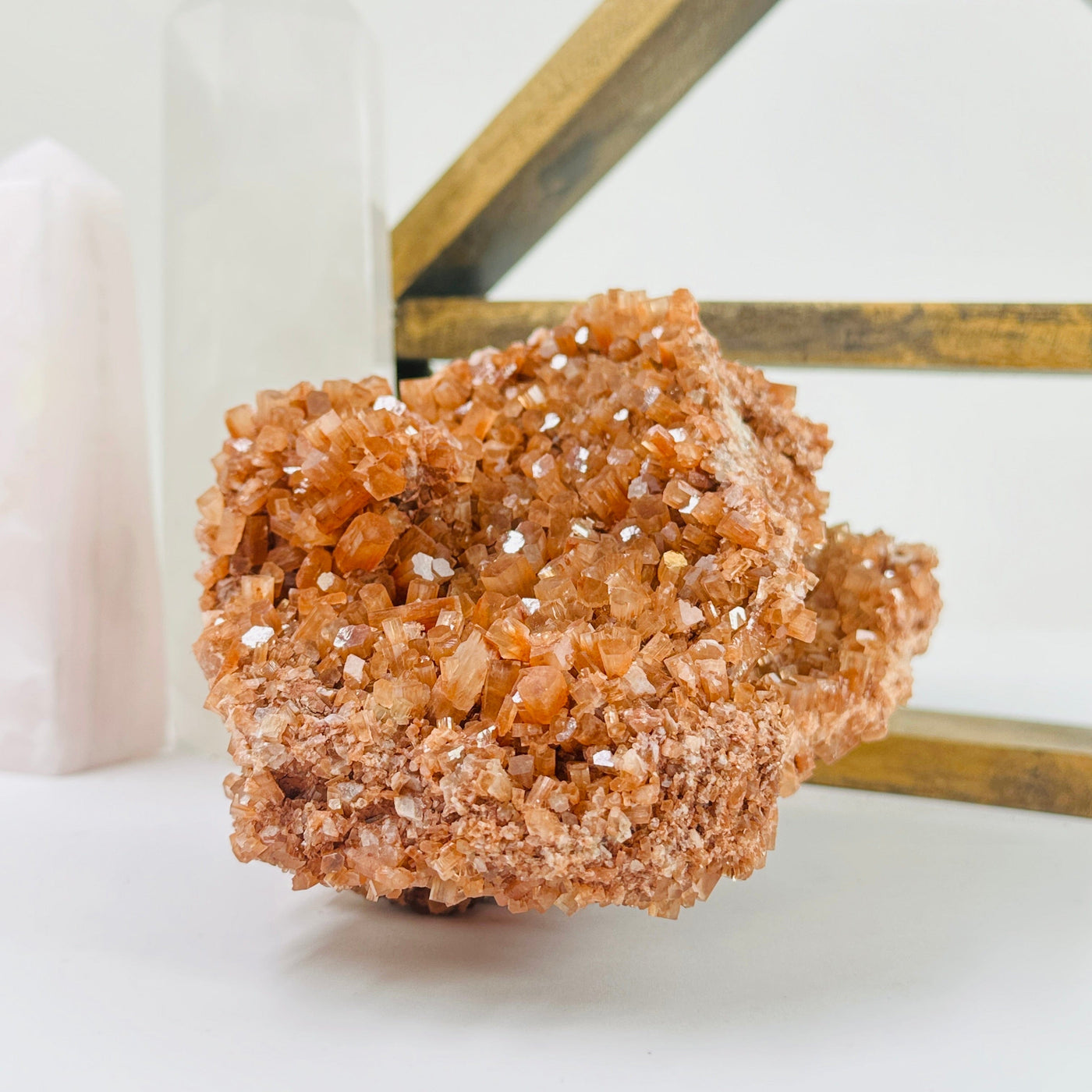 aragonite cluster with decorations in the background