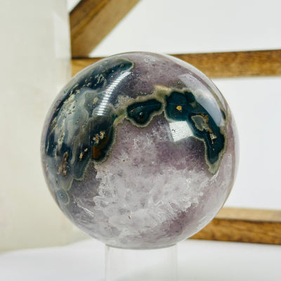 amethyst sphere with decorations in the background