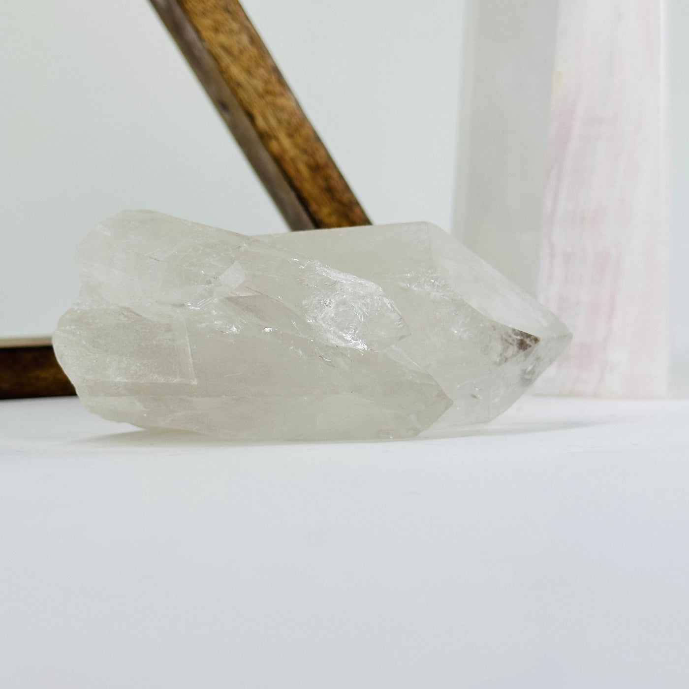 crystal quartz cluster with decorations in the background