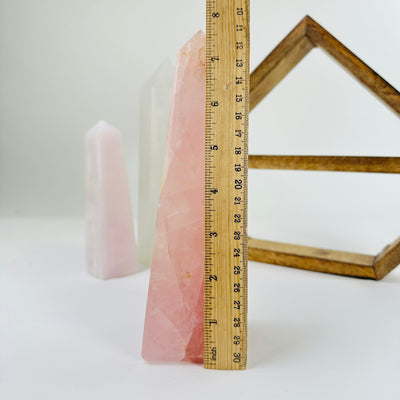rose quartz obelisk with decorations in the background