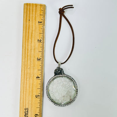 crystal quartz ornament next to a ruler for size reference