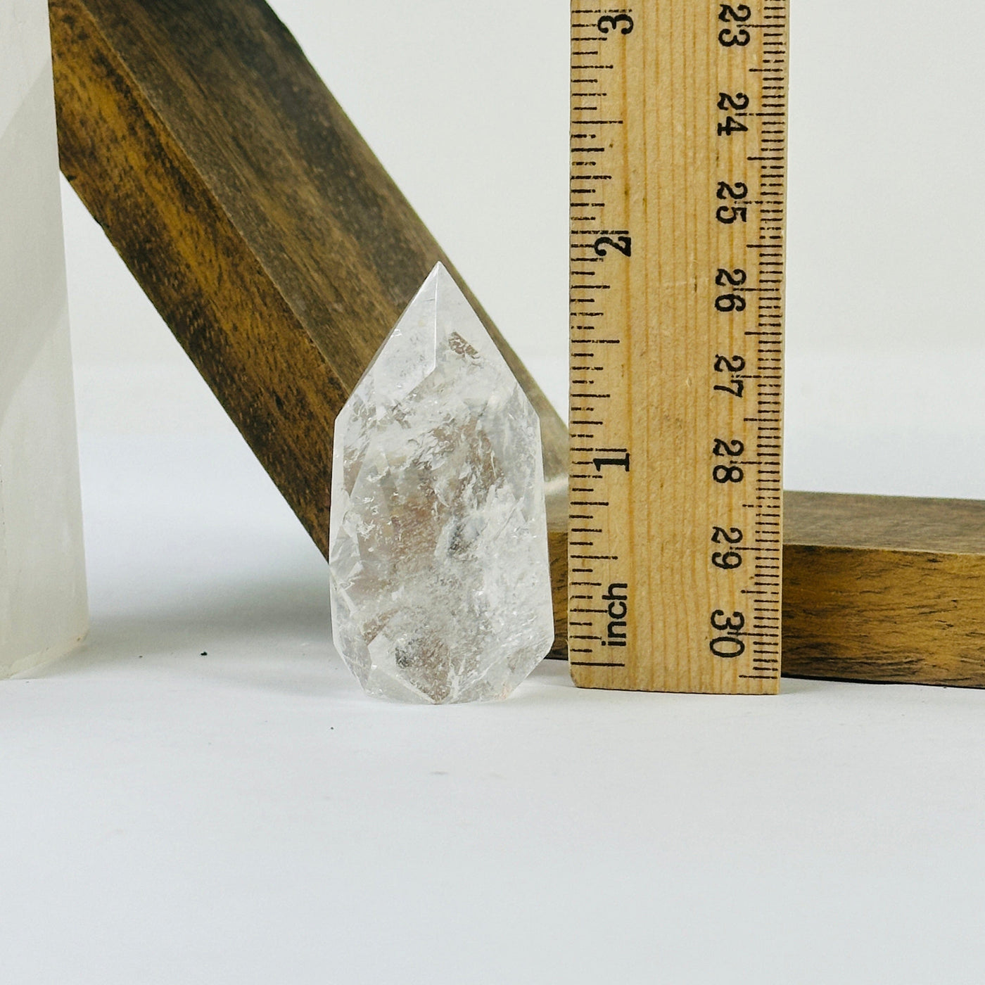 crystal quartz point with decorations in the background