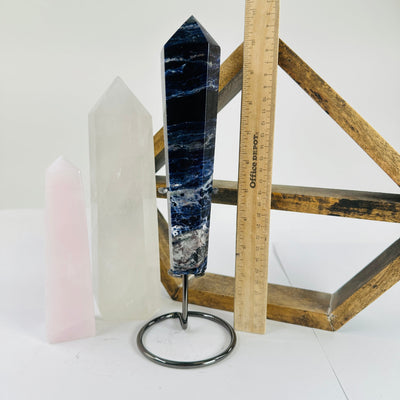 sodalite point next to a ruler for size reference