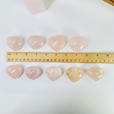 Rose Quartz Heart next to a ruler for size reference