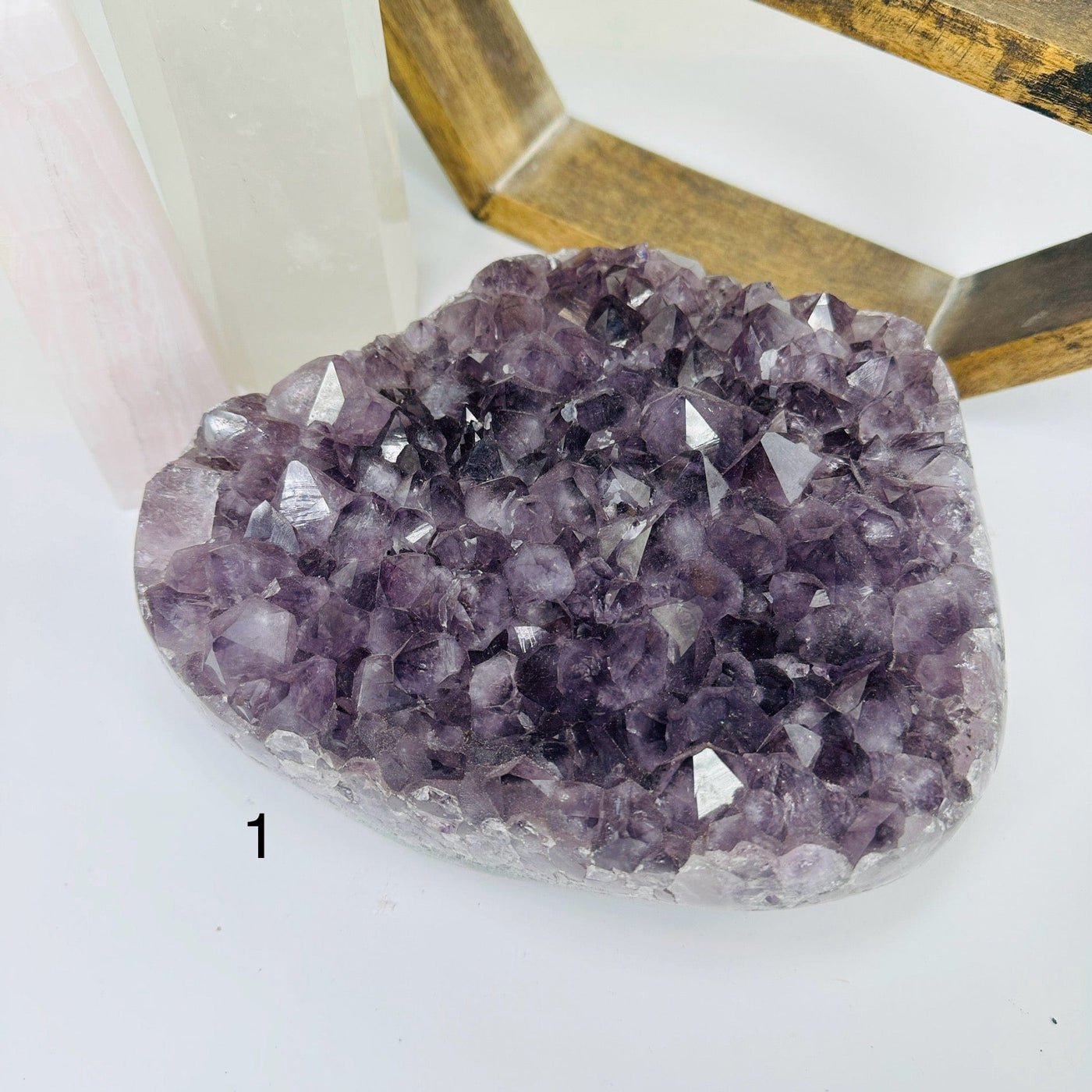 amethyst cluster with decorations in the background