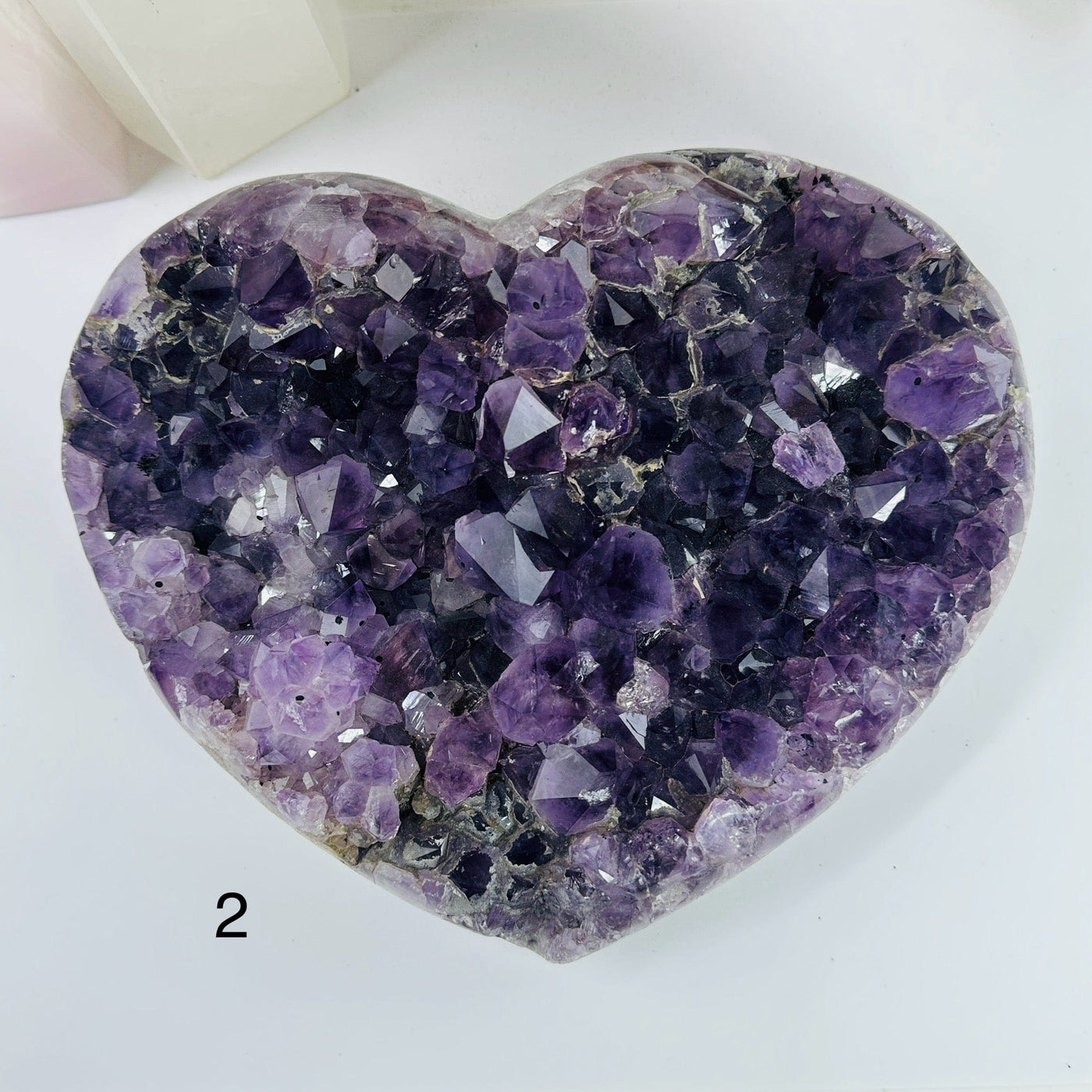 amethyst heart with decorations in the background