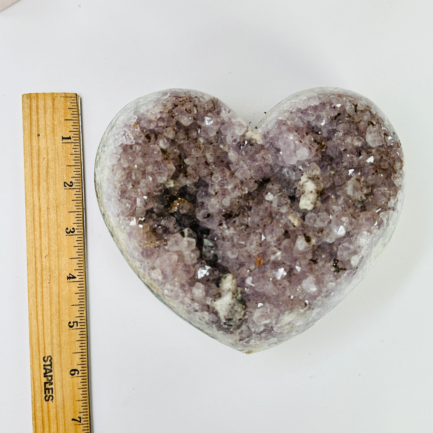 amethyst heart next to a ruler for size reference