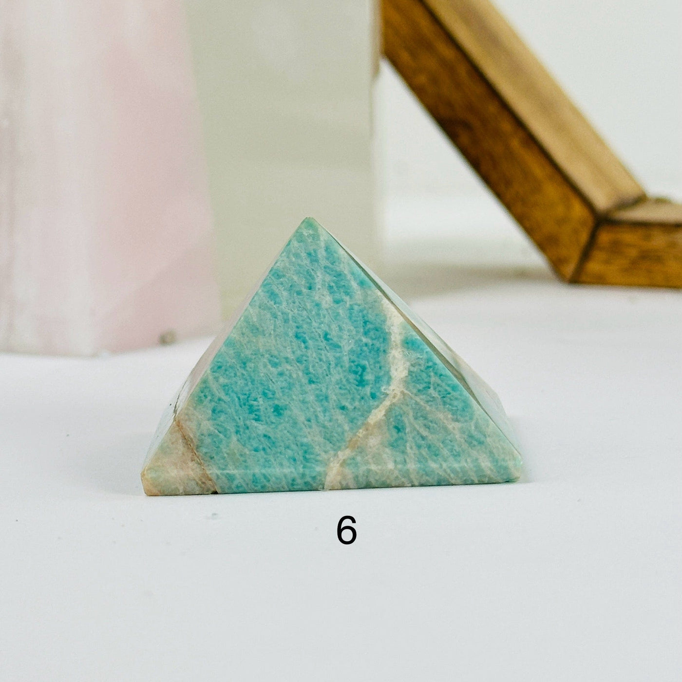 amazonite pyramid with decorations in the background