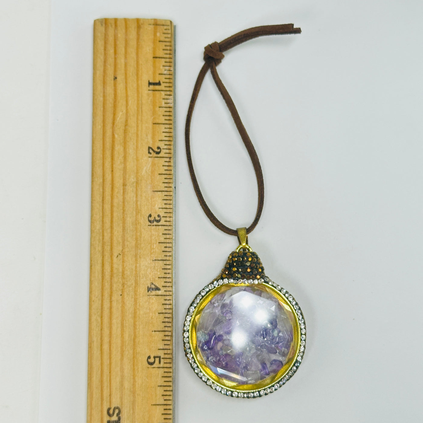 amethyst ornament next to a ruler for size reference