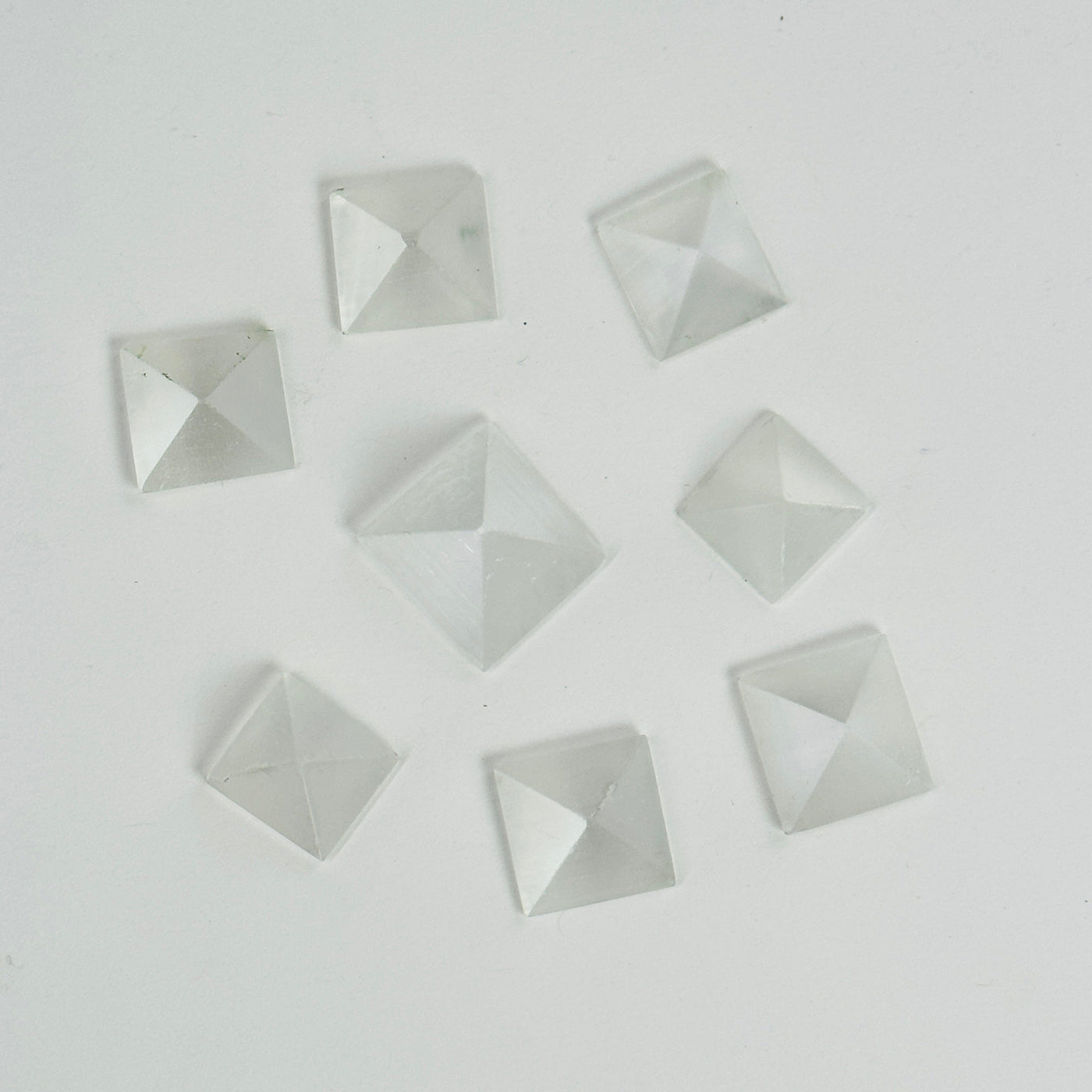 selenite pyramids on white background