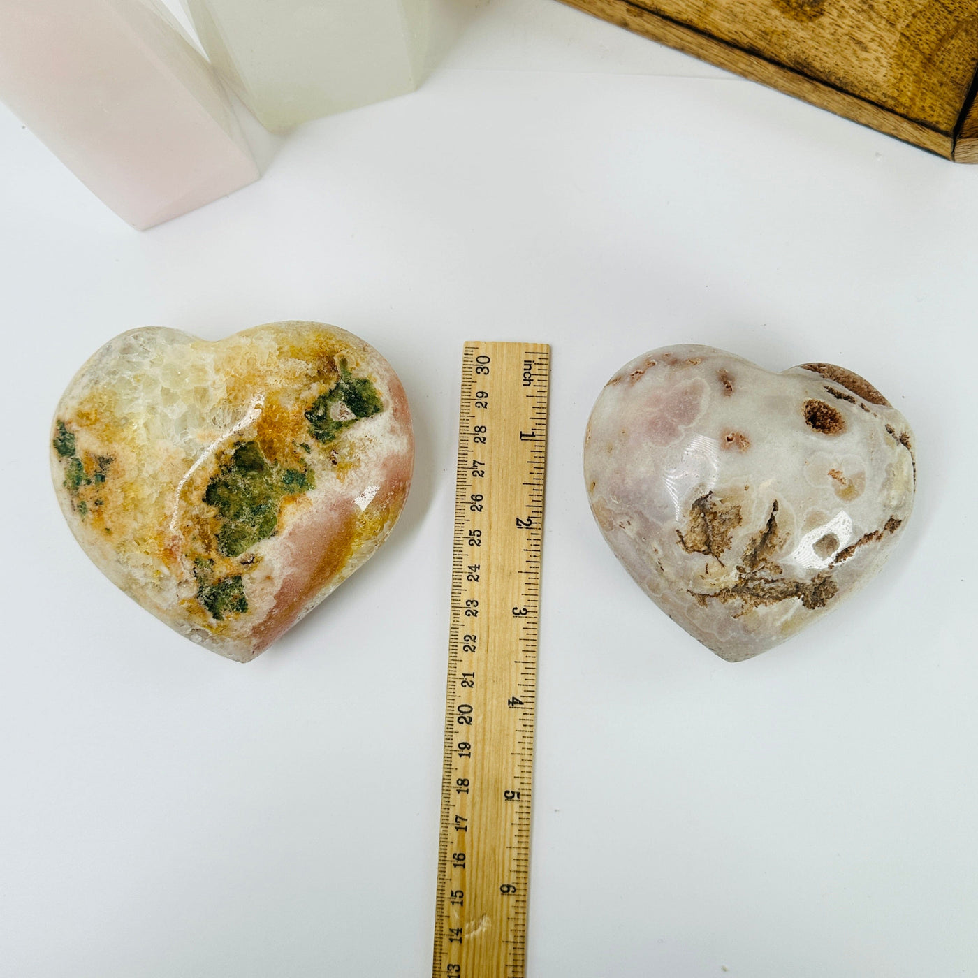 pink amethyst heart next to a ruler for size reference