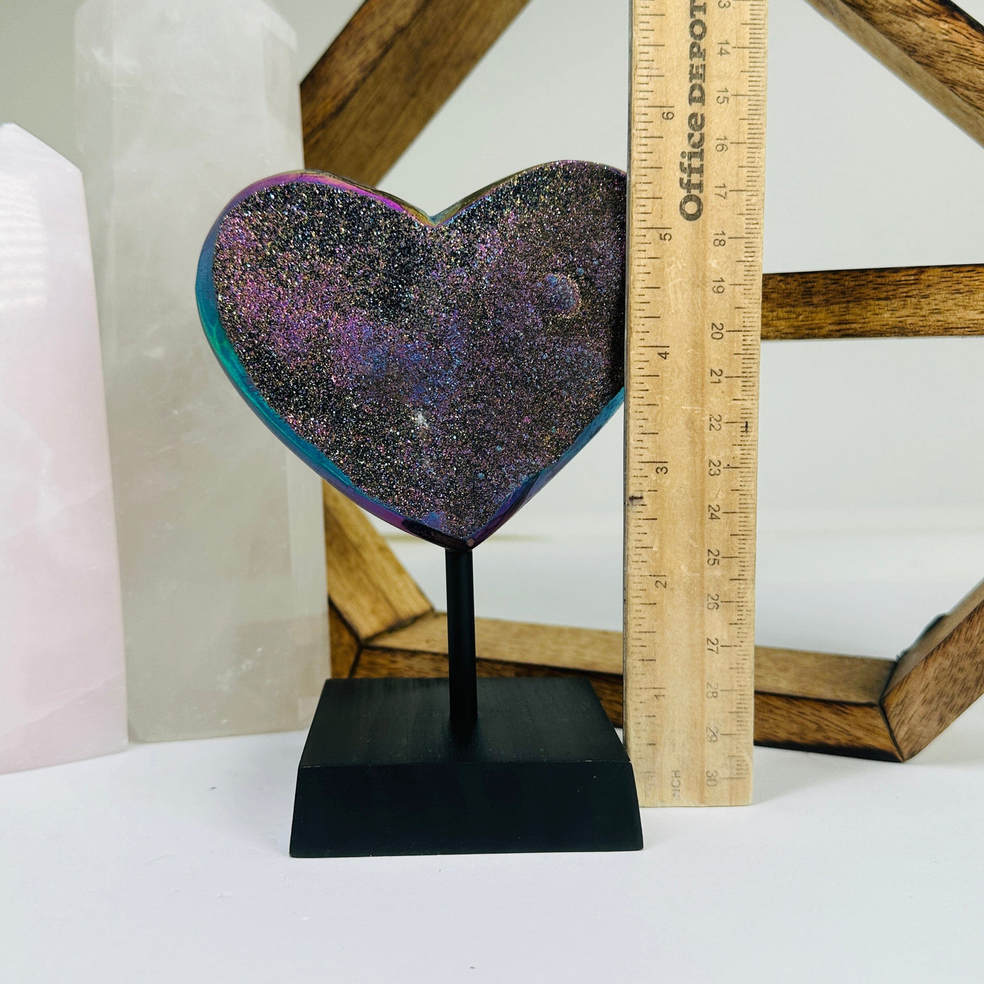 amethyst heart on stand next to a ruler for size reference