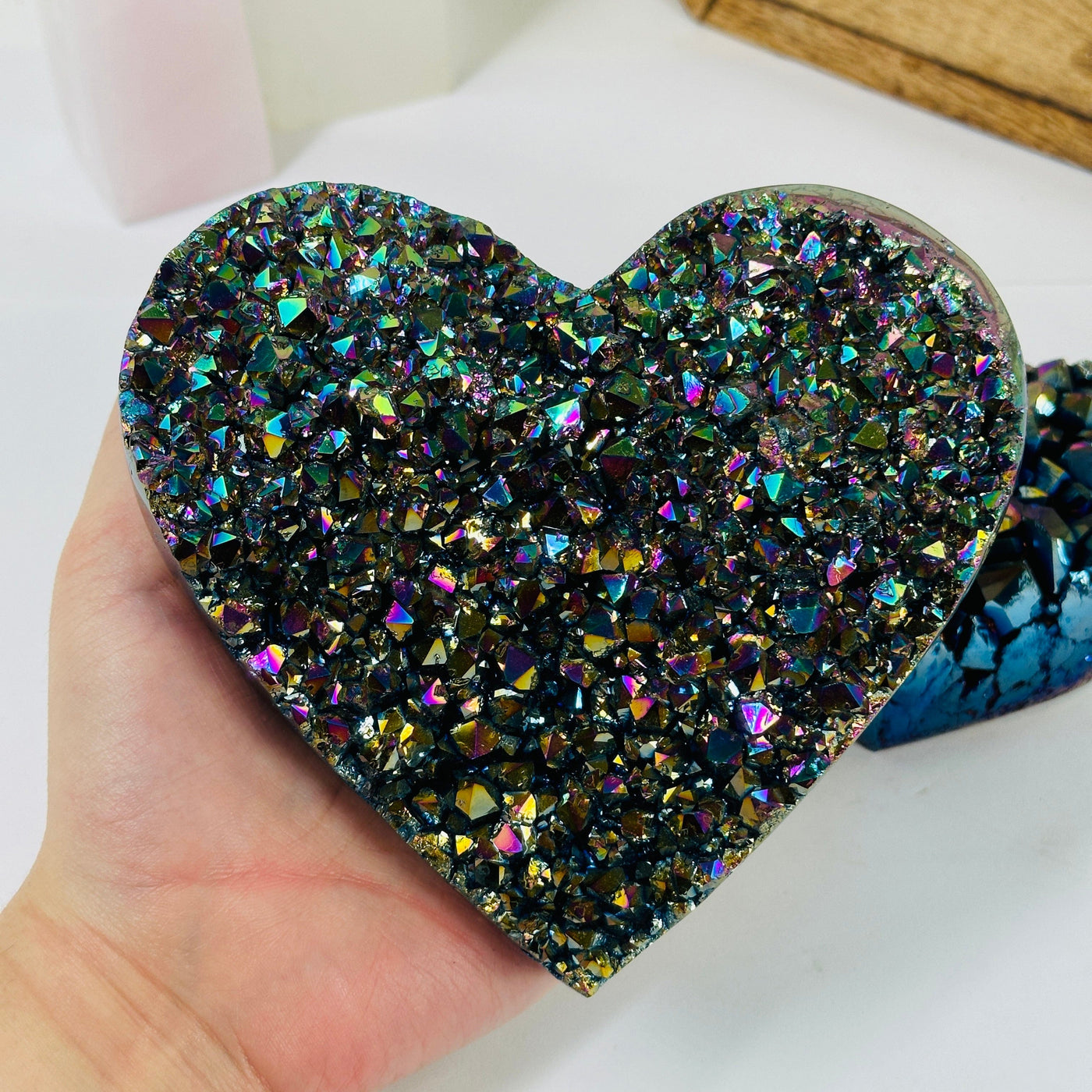 rainbow titanium coated heart with decorations in the background