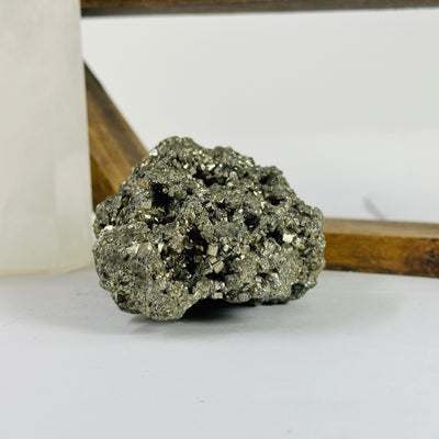 pyrite cluster with decorations in the background