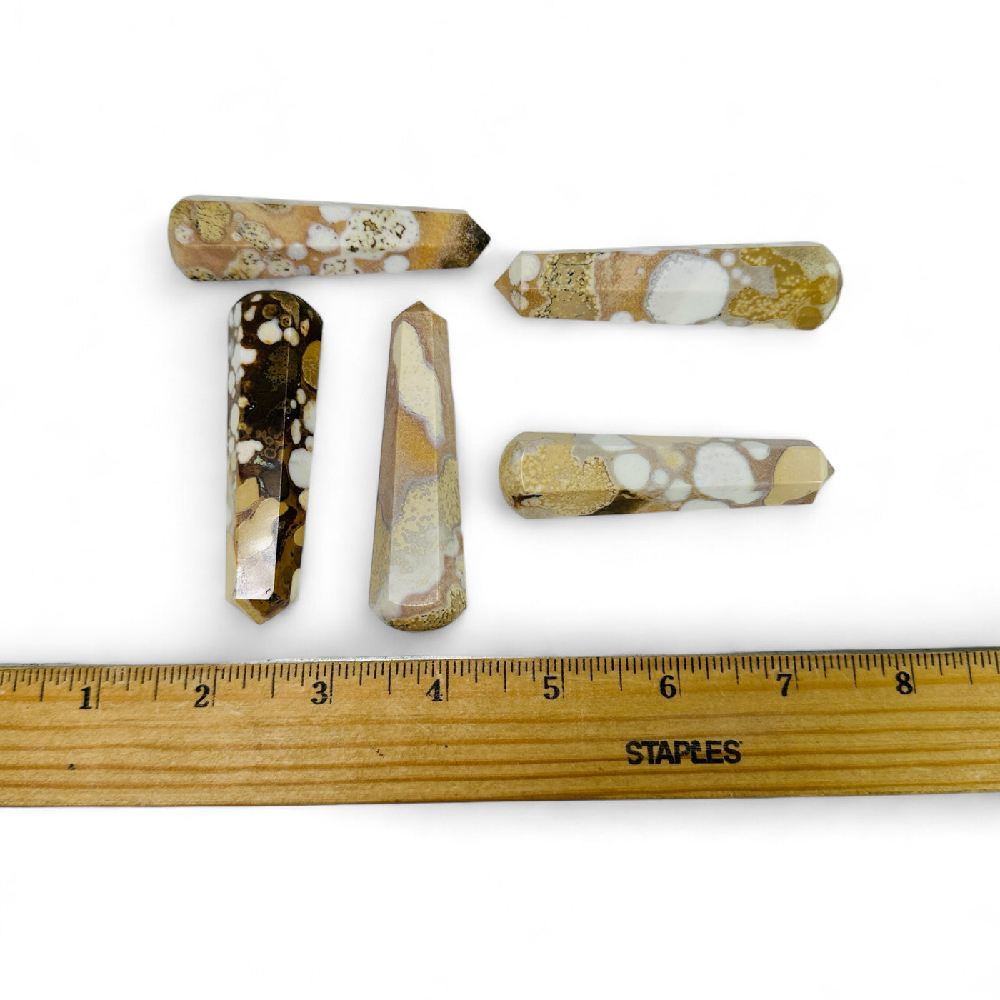 Leopard Skin Rhyolite Massage Points next to a ruler for size reference.