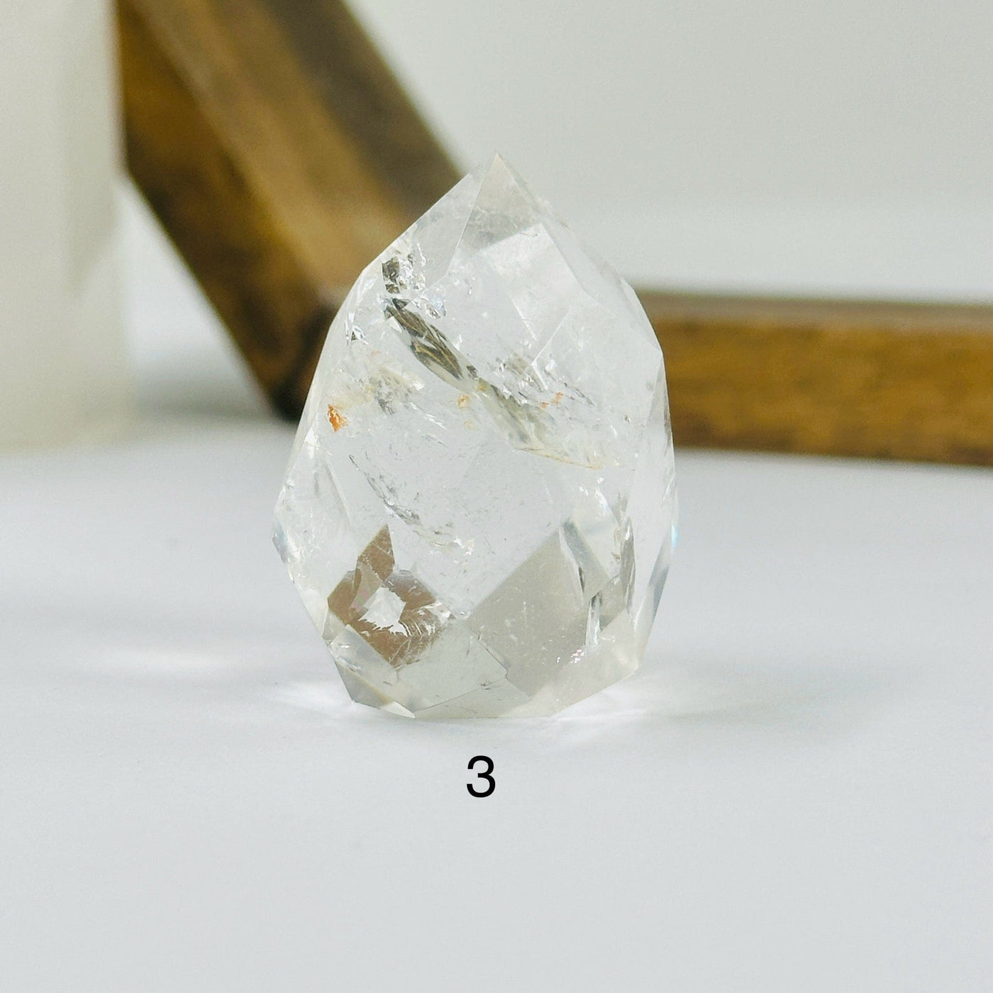 crystal quartz point with decorations in the background