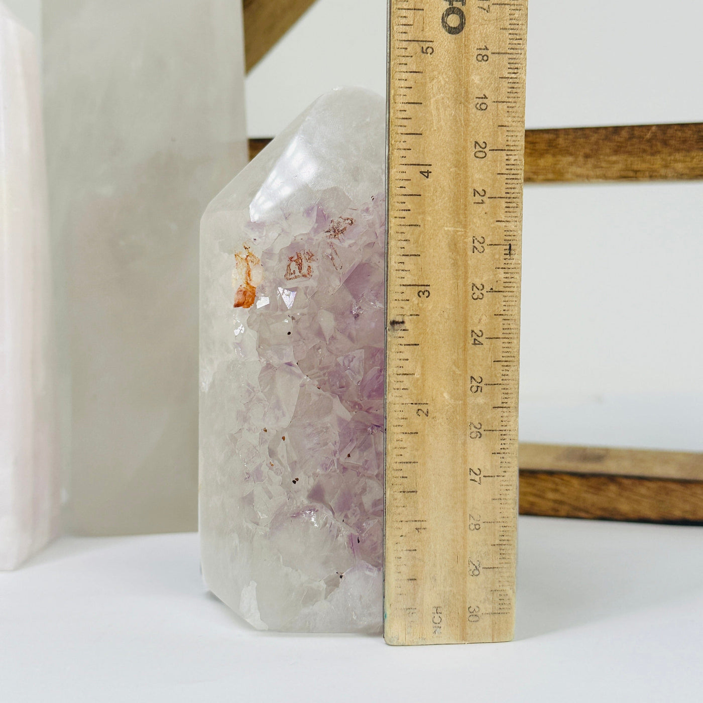 amethyst point next to a ruler for size reference