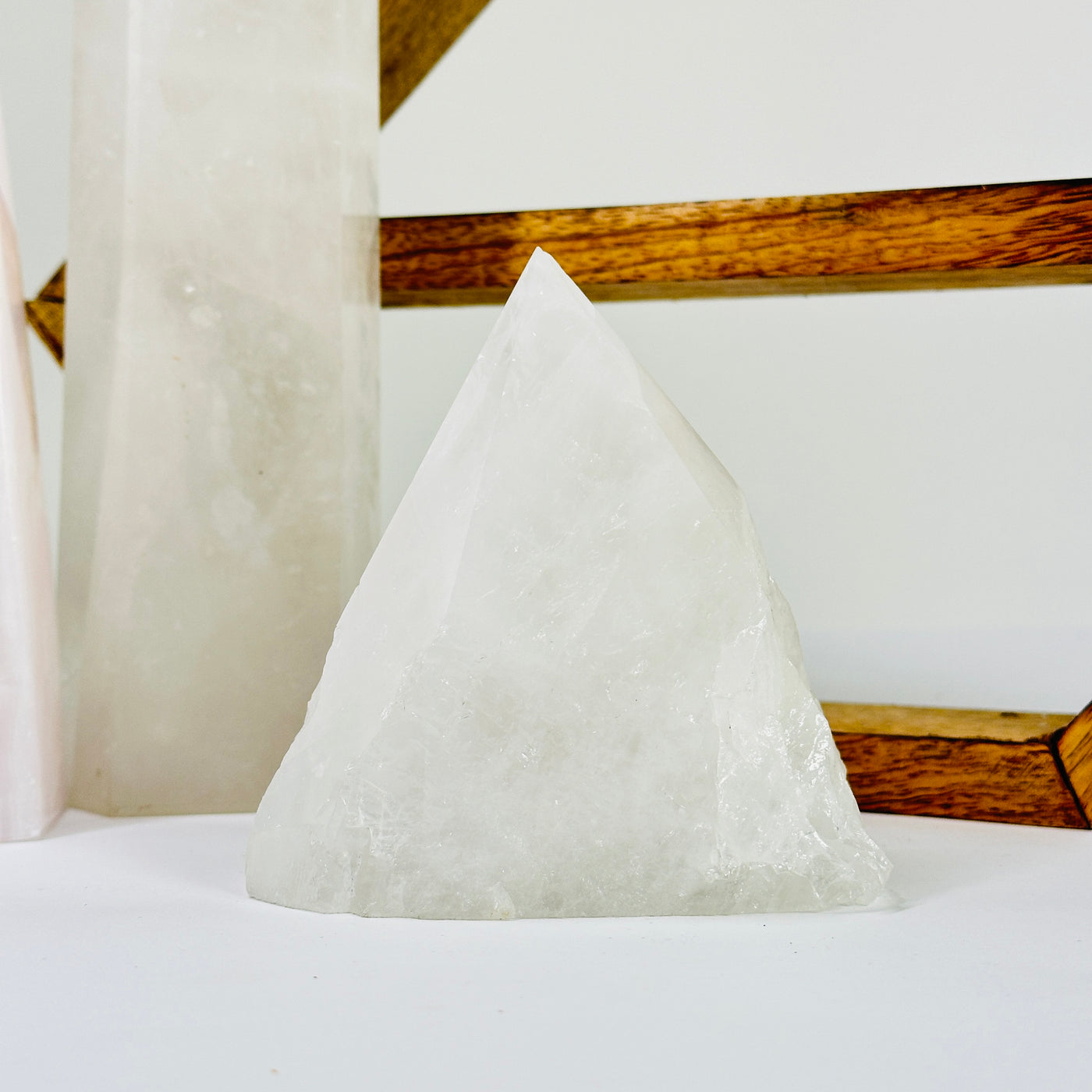 crystal quartz point with decorations in the background