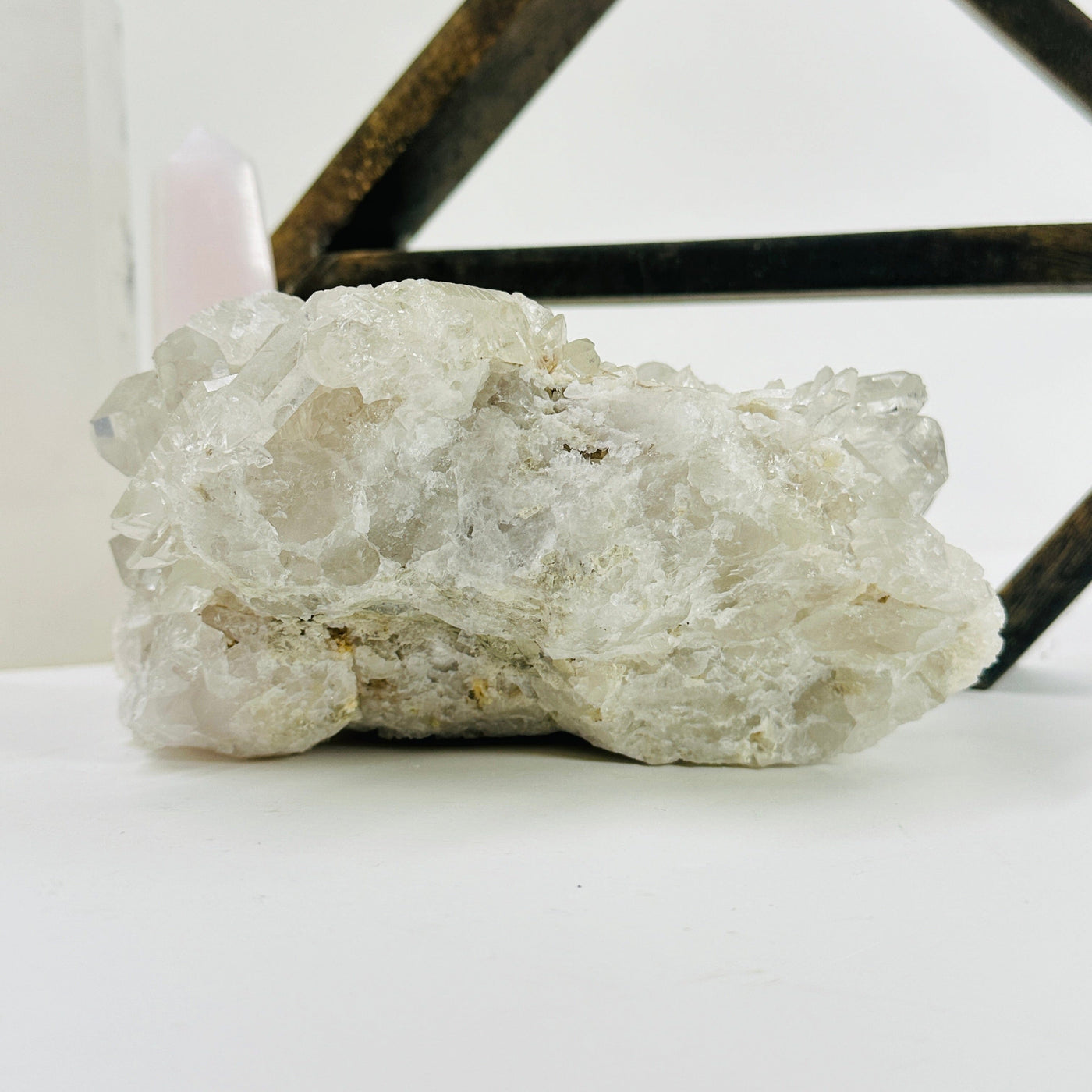 crystal quartz cluster with decorations in the background