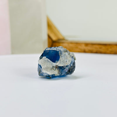 blue fluorite with decorations in the background