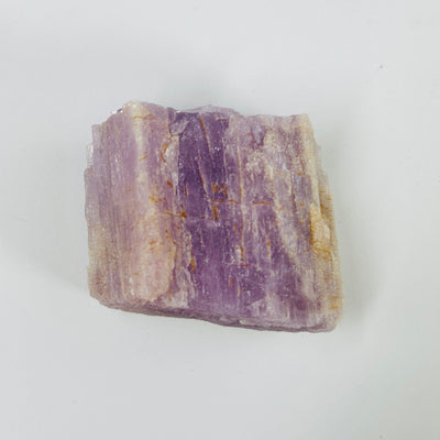 kunzite with decorations in the background