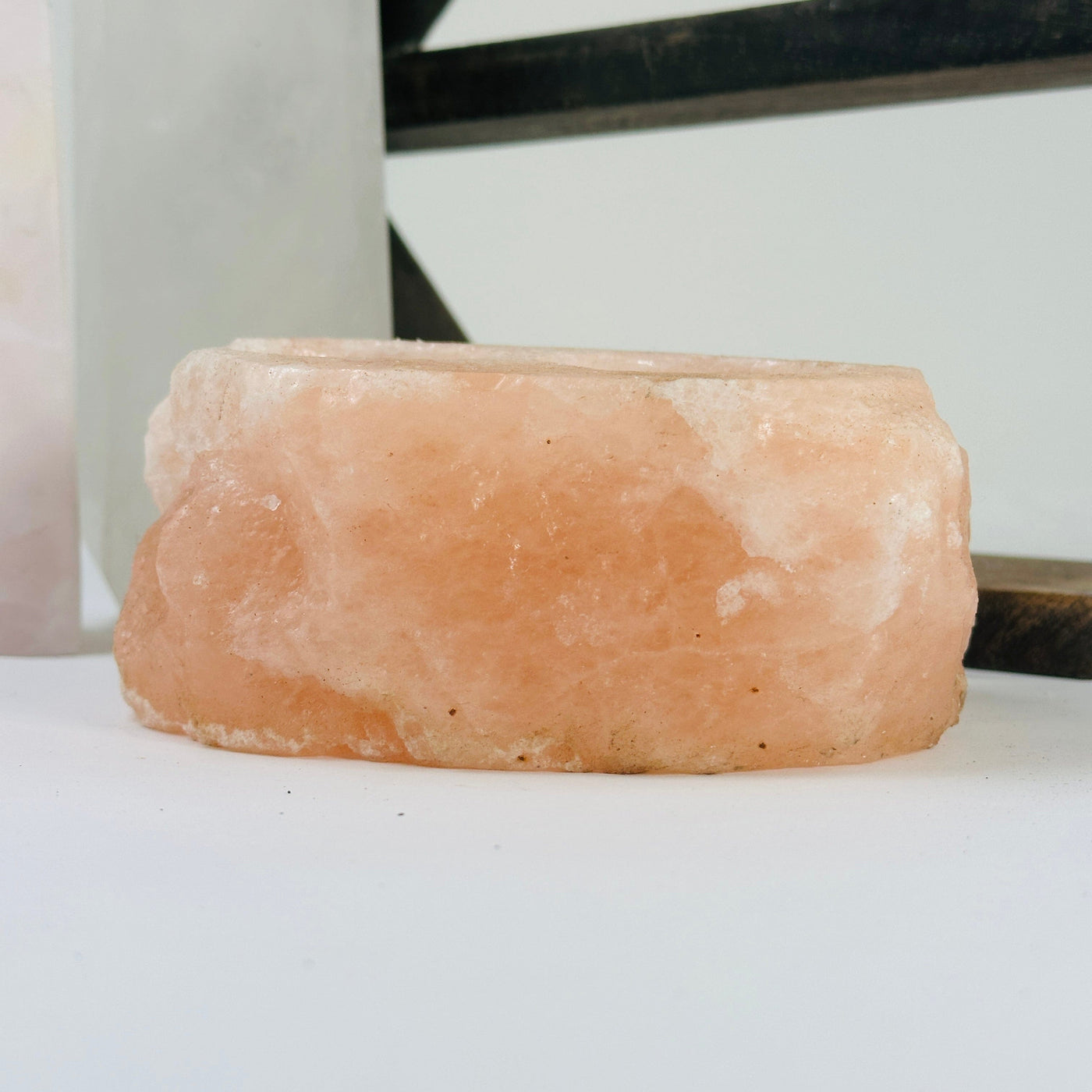 Himalayan salt candle holder with decorations in the background