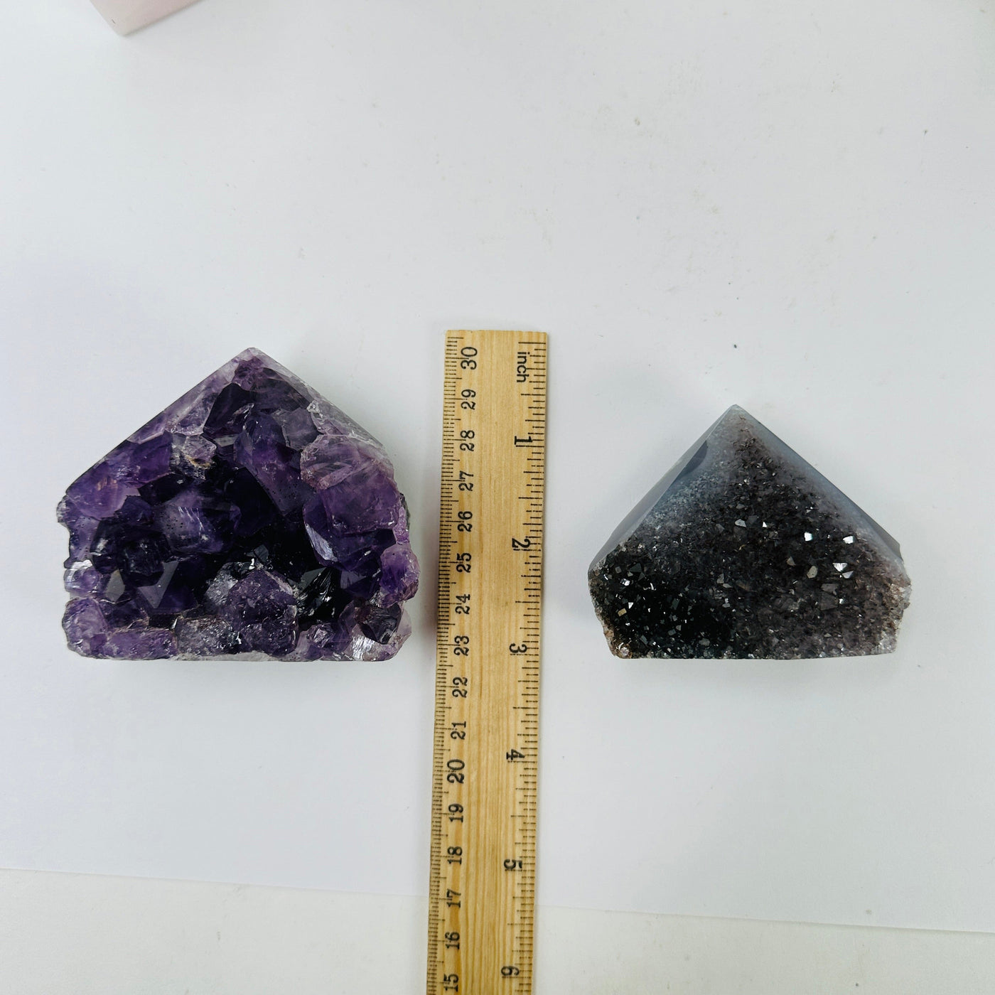 amethyst points next to a ruler for size reference