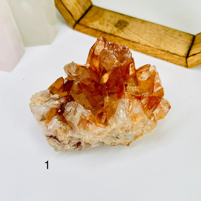 tangerine quartz with decorations in the background