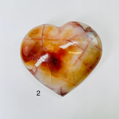 carnelian heart with decorations in the background