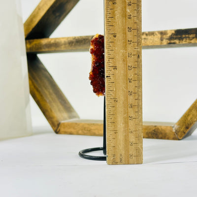 citrine on metal stand with decorations in the background