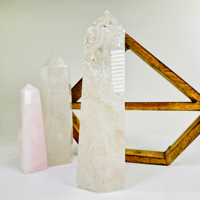 crystal quartz point with decorations in the background