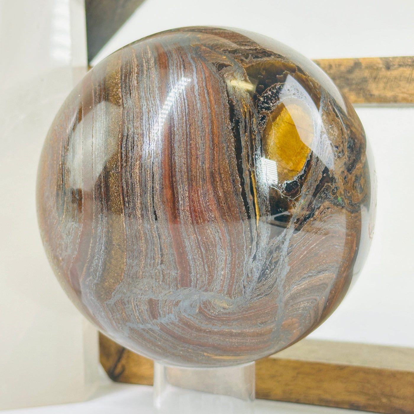 tigers eye sphere with decorations in the background