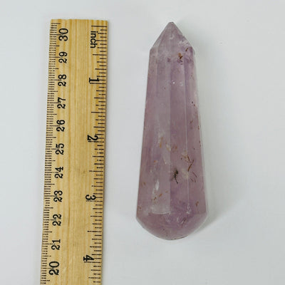amethyst massage wand next to a ruler for size reference