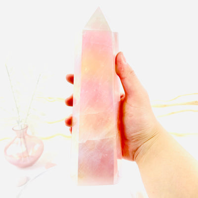 Angel Aura Rose Quartz Tower in hand for size reference