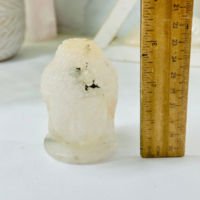 Crystal Quartz Carved Buddha Head - YOU CHOOSE variant H next to ruler for size reference