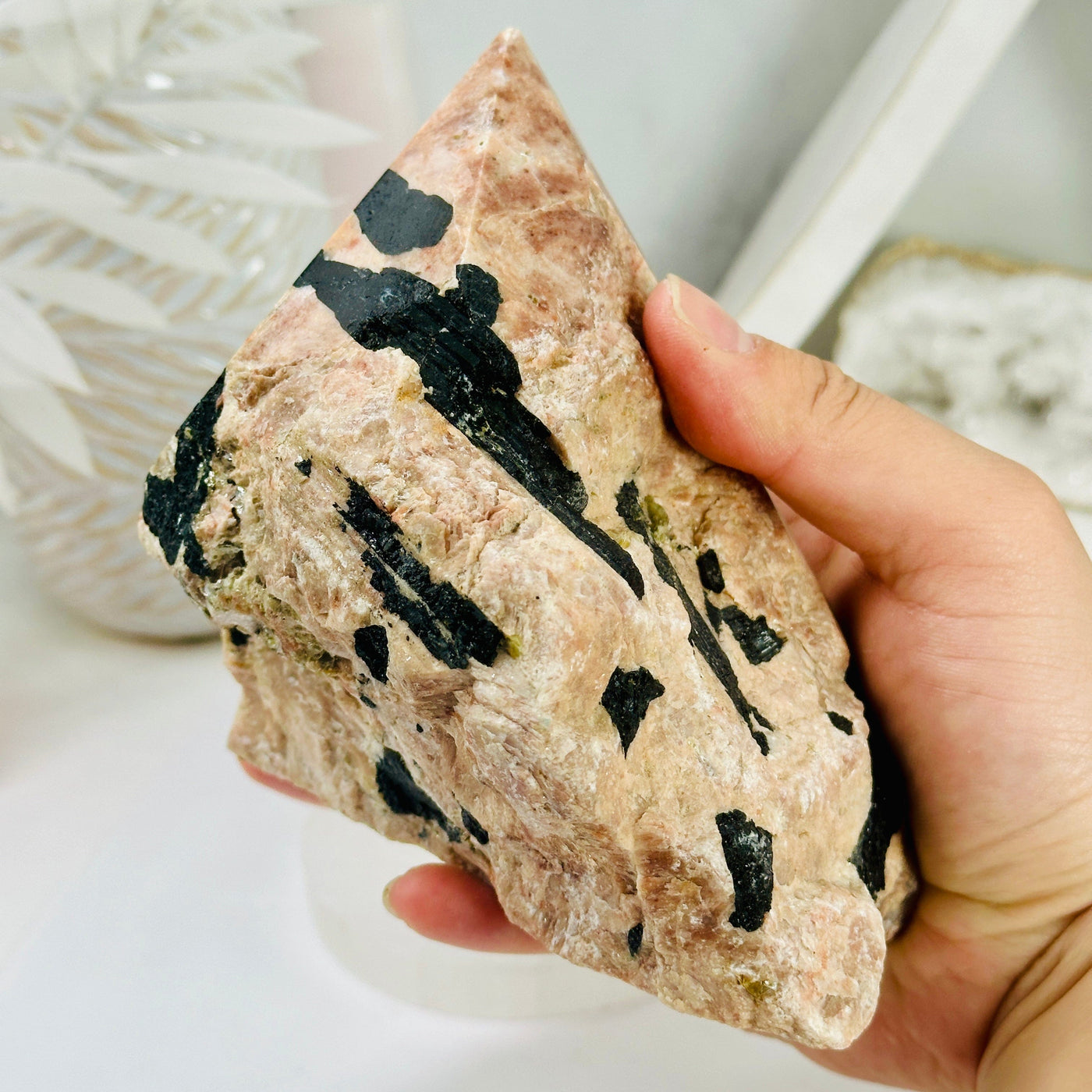 Feldspar with Black Tourmaline Semi Polished Crystal Point in hand for size reference