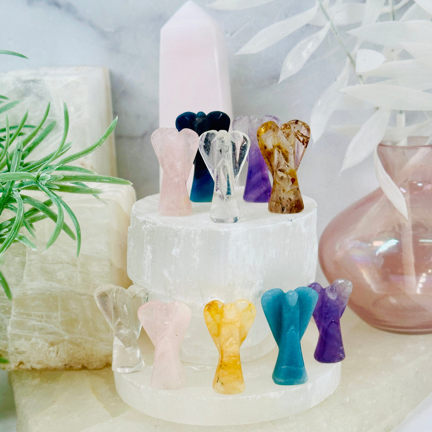 Gemstone Angels - Medium all variants on white pedestal with props in the background